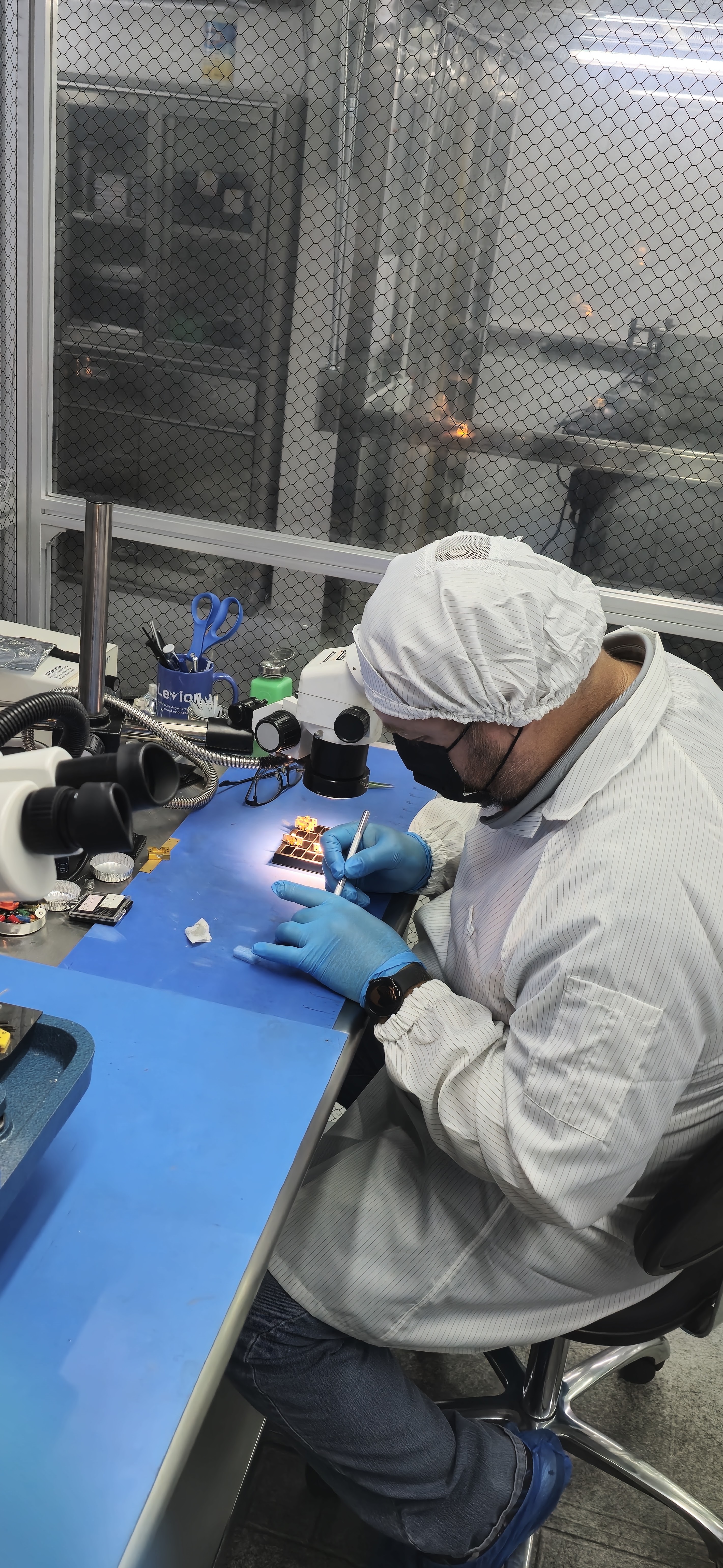 Technician performing precision optical work