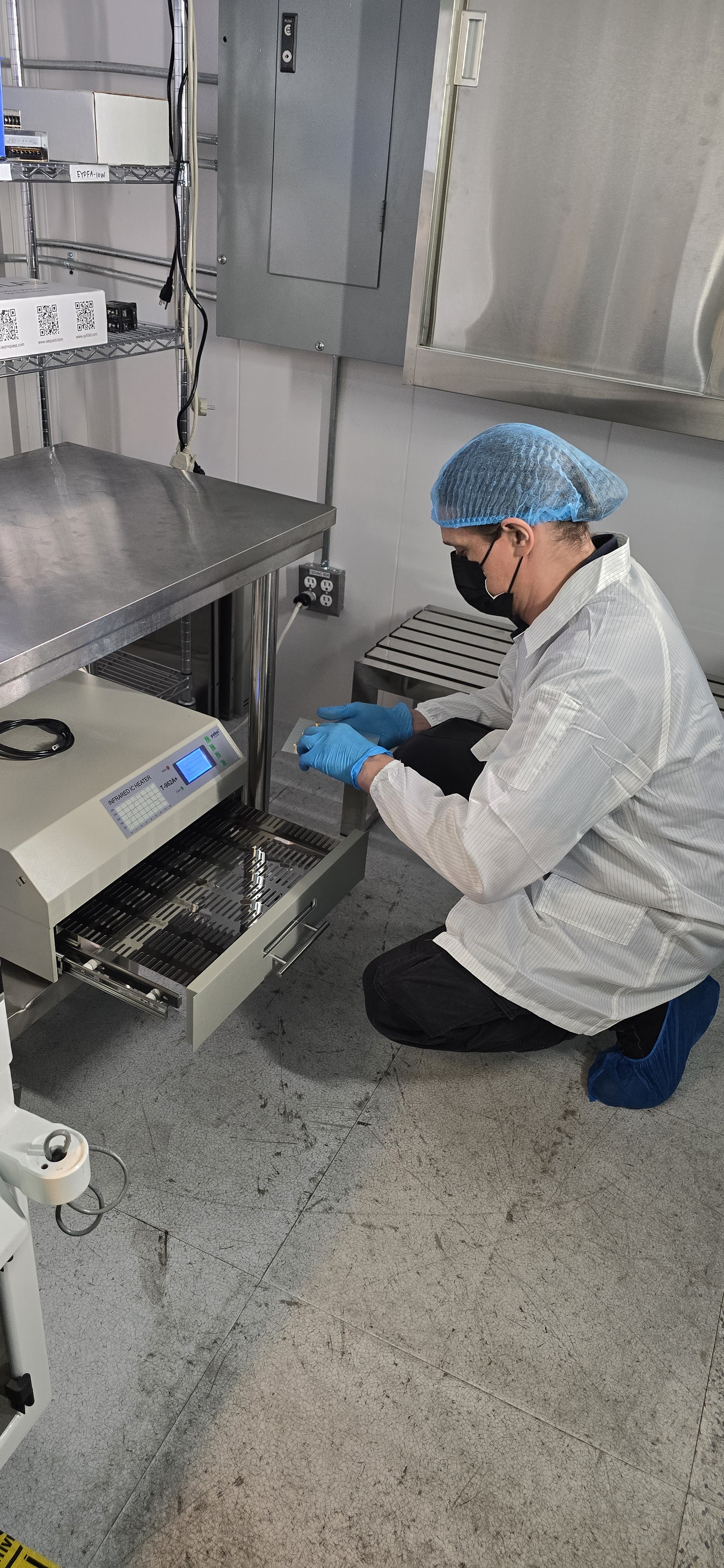 Technician loading reflow oven